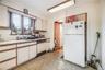 Kitchen featuring white appliances, white cabinetry, sink, and a baseboard heating unit