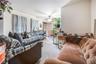Carpeted living room featuring ceiling fan