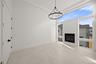 Family room featuring marble finish flooring, a glass covered fireplace, and a chandelier