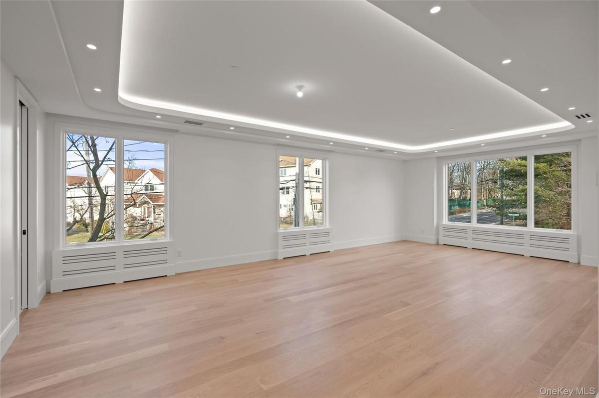Oversized dining room/ living room featuring LED tray ceilings