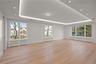 Oversized dining room/ living room featuring LED tray ceilings