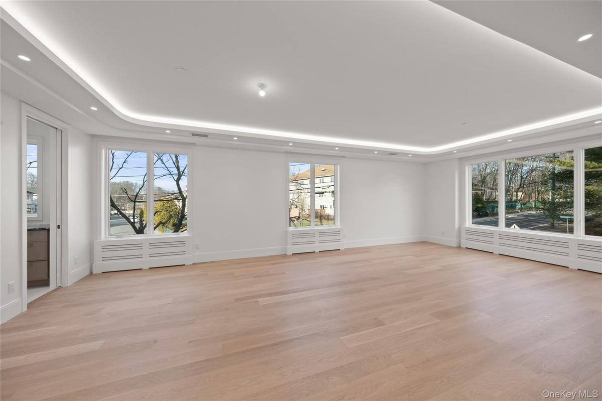 Oversized dining room/ living room featuring LED tray ceilings