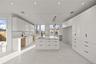 Kitchen with modern cabinets, white cabinetry, decorative light fixtures, light marble finish floors, and light stone countertops