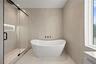 hotel-like spa bathroom featuring freestanding  bathtub,  and shower with luxury dual showerheads