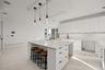 Kitchen featuring hanging light fixtures by the breakfast bar