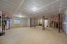 Full unfinished basement featuring well windows