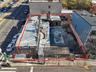 Aerial view of property and surrounding area featuring property parcel outlined