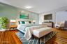 Bedroom with baseboards and hardwood / wood-style floors