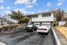 Split foyer home featuring fence, an attached garage, and aphalt driveway
