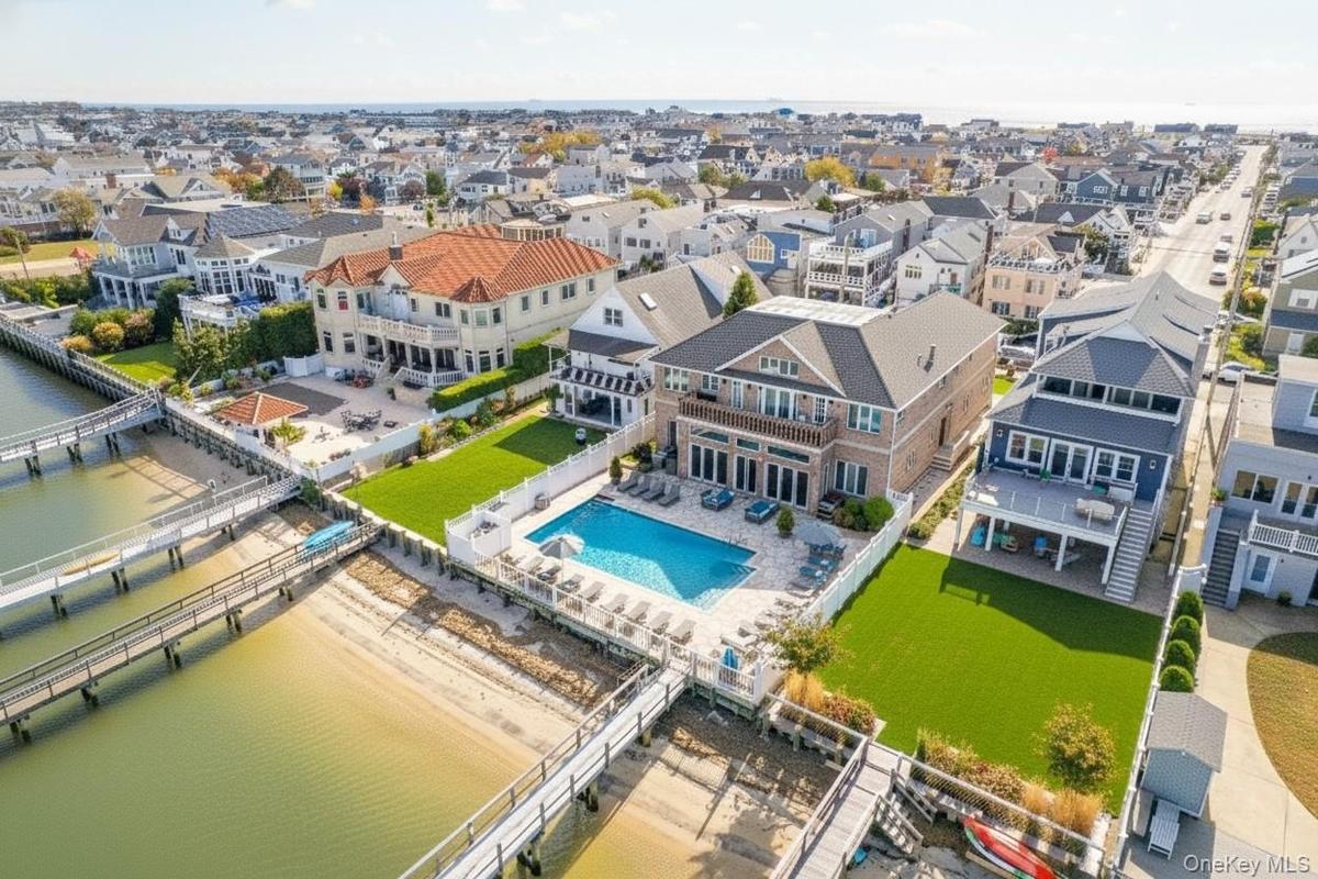 Aerial view of residential area with a pool area and a nearby body of water