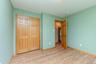 Unfurnished bedroom with light wood-style floors, baseboards, and a closet