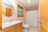 Bathroom with vanity, toilet, and curtained shower