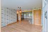 Unfurnished room featuring wallpapered walls, a baseboard heating unit, light wood-style floors, and baseboards