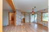 Foyer entrance featuring a baseboard radiator, wallpapered walls, baseboards, and light wood-type flooring