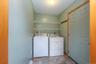 Laundry room featuring washer and clothes dryer, baseboards, and light stone finish flooring