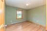Spare room featuring a baseboard heating unit, light wood finished floors, and baseboards