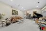 Living room featuring lofted ceiling, stairs, and recessed lighting