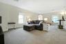 Living room with light colored carpet and healthy amount of natural light