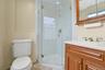 Bathroom featuring vanity, a stall shower, and light tile patterned floors