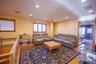 Living room featuring light wood-type flooring, radiator heating unit, and recessed lighting