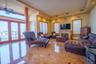 Living area featuring recessed lighting, a glass covered fireplace, radiator heating unit, and ceiling fan