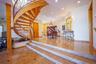 Stairway with recessed lighting and a chandelier
