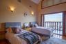 Bedroom featuring wood finished floors, radiator heating unit, and access to outside