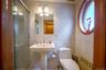 Bathroom featuring tile walls, radiator heating unit, a shower stall, tasteful backsplash, and a chandelier