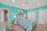 Recessed lighting illuminates a space featuring a textured carpet floor and white bi-fold closet doors