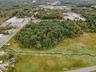 Aerial view of property's location featuring a heavily wooded area