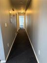 Corridor with dark colored carpet