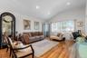 Living room featuring vaulted ceiling and light hardwood / wood-style flooring