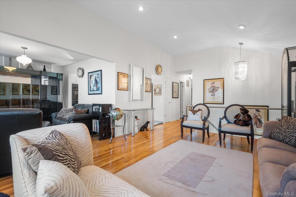 Living room with an inviting chandelier and light wood-type flooring