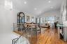 Living room featuring light hardwood / wood-style flooring, lofted ceiling, and a notable chandelier