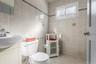 Bathroom featuring tile patterned flooring and tile walls