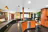 Kitchen featuring wood finish cabinetry, hanging light fixtures, and dark stone countertops