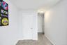 Bedroom featuring light carpet and baseboards