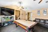 Living room with ceiling fan, carpet floors, and pool table