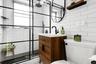 Full bath with vanity, a shower stall, tile walls, and tasteful backsplash