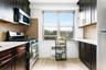 Kitchen featuring backsplash, stainless steel appliances, and dark cabinets
