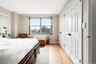 Bedroom with light wood-type flooring and baseboards