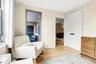 Living area with light wood-style flooring and baseboards