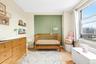 Bedroom featuring a crib and light wood-style flooring
