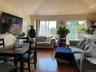 Living room featuring wood finished floors and vaulted ceiling