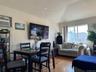 Dining area featuring wood finished floors and a wall mounted air conditioner