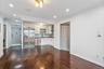 Kitchen with white cabinets, appliances with stainless steel finishes, ornamental molding, recessed lighting, and dark wood-type flooring