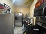 Kitchen with light tile patterned flooring and stainless steel appliances