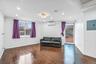 Living area with ornamental molding, electric panel, dark wood-style flooring, recessed lighting, and a wall mounted air conditioner