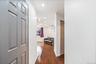 Corridor featuring ornamental molding, recessed lighting, dark wood-style floors, and an AC wall unit