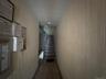 Hallway featuring stairway and wood walls
